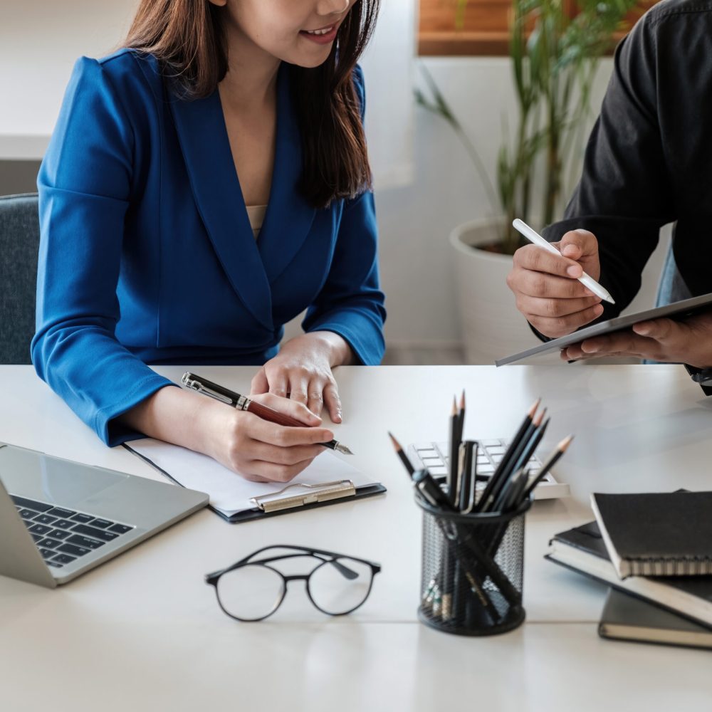 Asian business adviser meeting to analyze and discuss the situation on the financial report in the meeting room.Investment Consultant,Financial Consultant,Financial advisor and accounting concept.