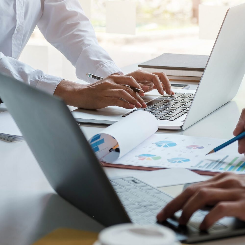 Business team analyzing income charts and graphs with modern laptop computer. Close up.Business analysis and strategy concept.